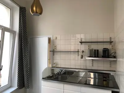 a kitchen with a sink and a counter top at Olives in Brussels