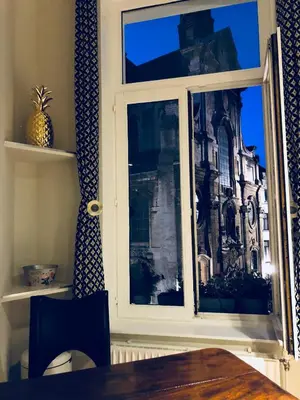 a window with a view of a building at Olives in Brussels