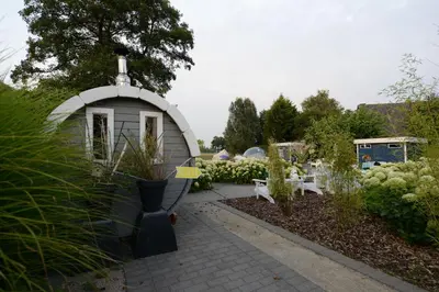 a garden with a small dome house in the middle at Guesthouse De Witte Merel Deluxe in Tessenderlo