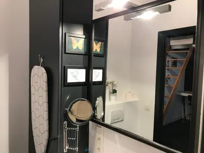 a black and white bathroom with a mirror at Modern cozy studio with backyard in Antwerp