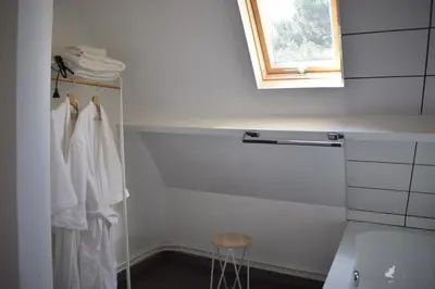 a bathroom with white towels and a window at De Pauw B&B in Zele