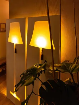a room with two lamps and a plant in front of a mirror at A Place Antwerp - Boutique Suites & Flats - Vrijdagmarkt 1 in Antwerp