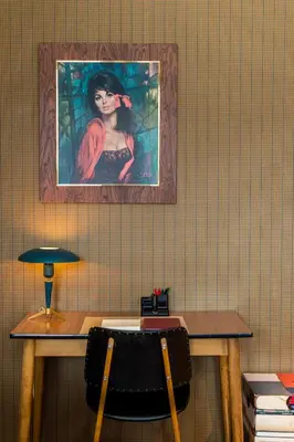 a table with a picture of a woman on the wall at A Place Antwerp - Boutique Suites & Flats - Vrijdagmarkt 1 in Antwerp
