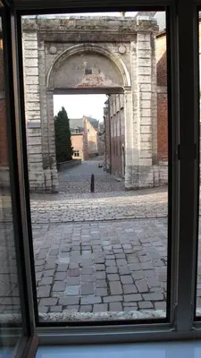 a view of an archway through a window at Hotel Guesthouse Begijnhof in Leuven