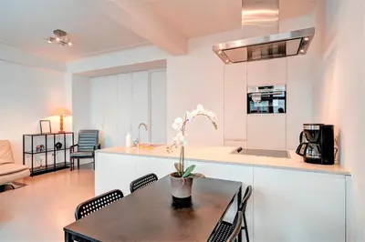 a kitchen and dining room with a table and chairs at The Meir Lodge. Apartments in heart of Antwerp in Antwerp