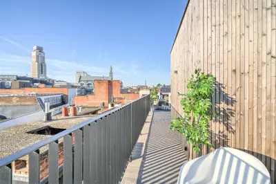 a balcony with a view of a city at The Meir Lodge. Apartments in heart of Antwerp in Antwerp