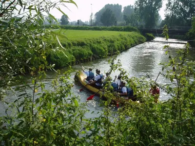 a group of people in a boat on a river at B&B Vallis Dyliae in Korbeek-Dijle