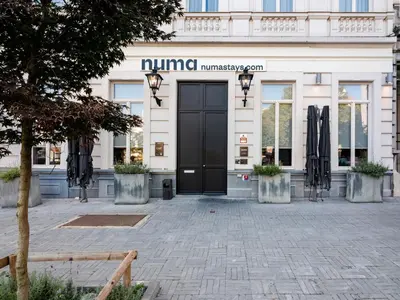 a entrance to a building with a black door at Numa Brussels Lief in Brussels