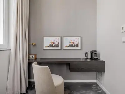 a desk in a room with two pictures on the wall at Numa Brussels Lief in Brussels