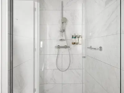 a bathroom with a shower with a glass door at Numa Brussels Lief in Brussels
