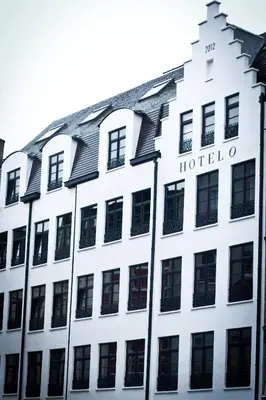 a white building with a hotel sign on it at HotelO Kathedral in Antwerp