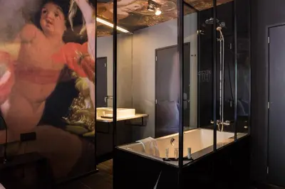 a bathroom with a shower and a sink and a mirror at HotelO Kathedral in Antwerp