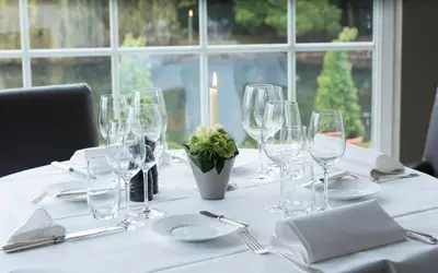 a table with wine glasses and a candle on it at Hotel Hippocampus in Mol