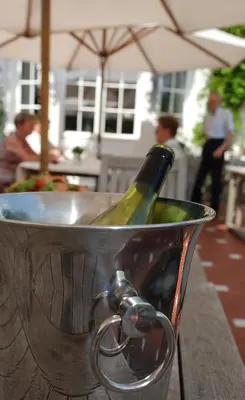 a bottle of wine in a bucket on a table at Hotel Hippocampus in Mol