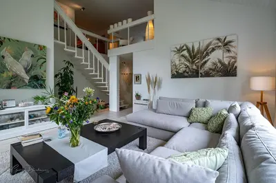 a living room with a couch and a table at Guest house Huize De Wit in Keerbergen