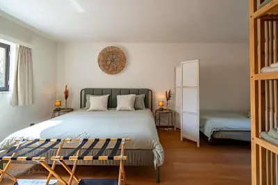 a bedroom with a large bed and a mirror at Guest house Huize De Wit in Keerbergen