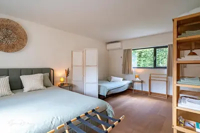a bedroom with two beds and a window at Guest house Huize De Wit in Keerbergen
