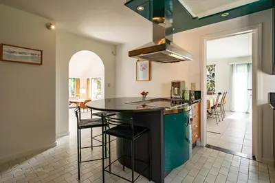 a kitchen with a island in the middle of a room at Guest house Huize De Wit in Keerbergen