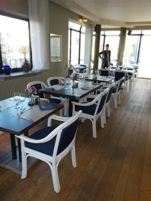 a row of tables and chairs in a restaurant at Hotel De Swaen in Herentals