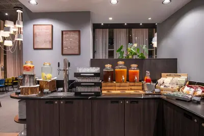a bar in a restaurant with a counter with food at Thon Hotel EU in Brussels