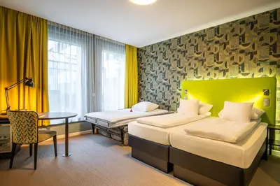 a hotel room with two beds and a table at Thon Hotel EU in Brussels