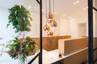 a dining room with a table with flowers and lights at Kaai11 - Riverview Lofts & Suites in Antwerp