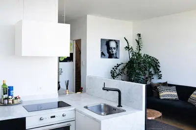 a kitchen with a sink and a living room at Kaai11 - Riverview Lofts & Suites in Antwerp