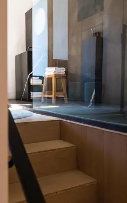 a room with a counter with a table and a stool at Kaai11 - Riverview Lofts & Suites in Antwerp