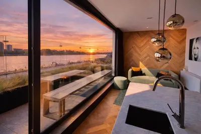 a house with a view of the water at Kaai11 - Riverview Lofts & Suites in Antwerp