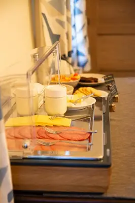 a tray of food on a table with food at B&B La Ferme de l'Hosté in Wavre