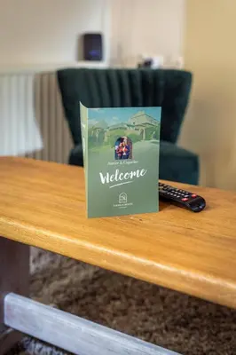 a book on a table with a remote control at B&B La Ferme de l'Hosté in Wavre
