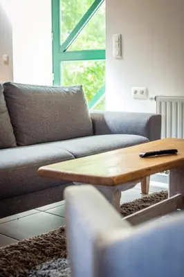 a living room with a couch and a coffee table at B&B La Ferme de l'Hosté in Wavre