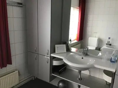 a bathroom with a white sink and a mirror at Guesthouse De Steenberg tweepersoonskamer met grote badkamer, kitchenette en tuinzicht op de eerste verdieping in Geel