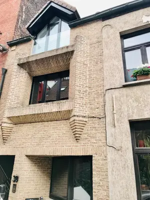 a brick building with windows on it at LivingTheMoment in Ghent