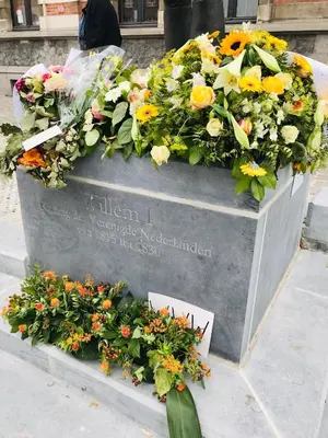 a wreath of flowers on a monument in front of a building at LivingTheMoment in Ghent