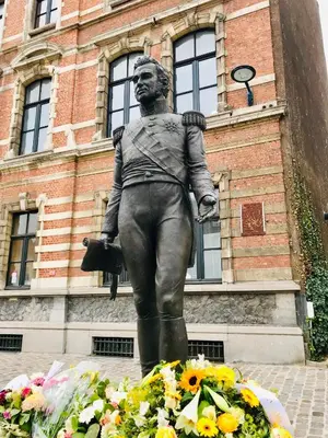 a statue of a man standing in front of a building at LivingTheMoment in Ghent