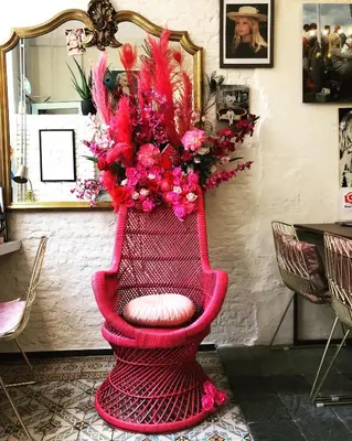 a pink chair with a bunch of flowers on it at Hotel Urban Dreams in Antwerp