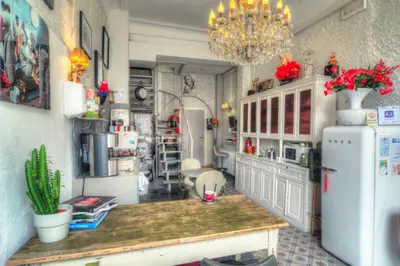 a kitchen with a refrigerator and a table in it at Hotel Urban Dreams in Antwerp