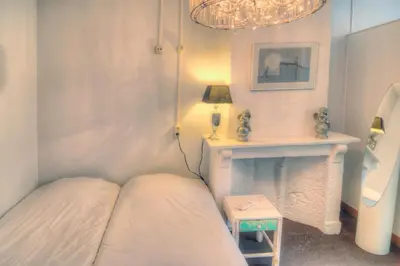 a living room with a bed and a fireplace at Hotel Urban Dreams in Antwerp