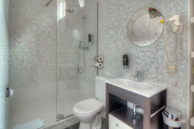 a bathroom with a toilet and a shower and a sink at Hotel Urban Dreams in Antwerp