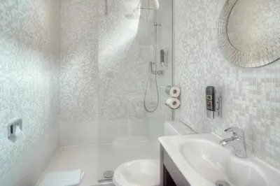 a bathroom with a shower and a toilet and a sink at Hotel Urban Dreams in Antwerp