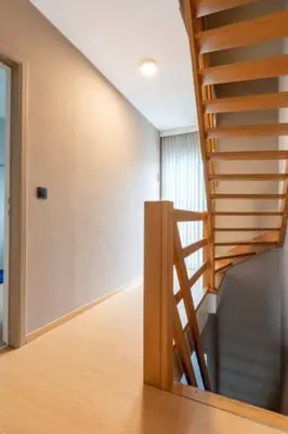 a staircase in a room with wooden floors at Room 