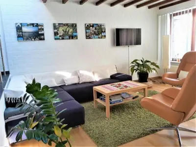a living room with a couch and a table at Room 