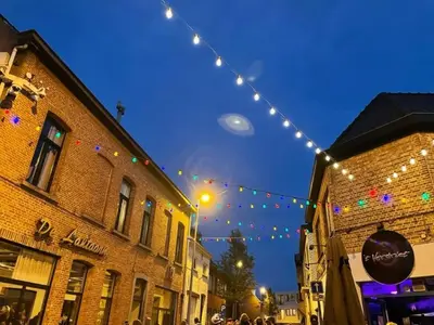 a string of lights over a street with buildings at Room 