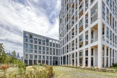 a large white building with a yard in front of it at B&B HOTEL Antwerpen Zuid in Antwerp