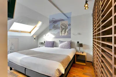 a bedroom with a large bed and a window at Boutique Hotel Saint-Géry in Brussels