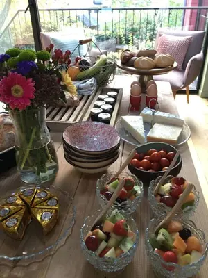 a table with bowls of food and plates of food at B&B PETIT PRINCE, GENT in Ghent