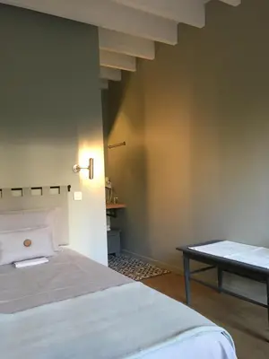 a bedroom with a bed and a table at B&B PETIT PRINCE, GENT in Ghent