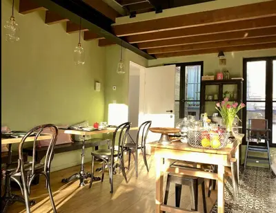 a kitchen with a table and chairs in a room at B&B PETIT PRINCE, GENT in Ghent