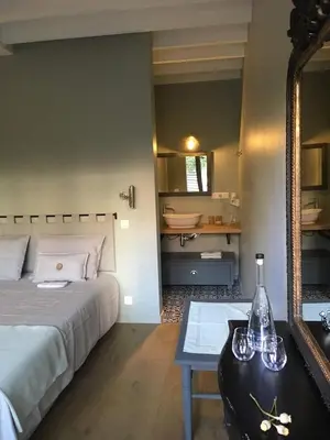 a bedroom with a bed and a table with a mirror at B&B PETIT PRINCE, GENT in Ghent